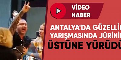 Antalya'da güzellik yarışmasında jürinin üstüne yürüdü.
